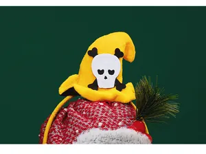 Close-up of yellow witch hat with heart-eyed skull on Halloween party headband decor