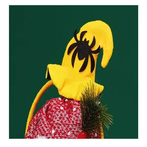 Close-up detail of yellow Halloween witch hat headband with black spider and red knit