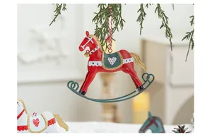 Detailed vintage red iron rocking horse ornament hanging on a Christmas tree branch