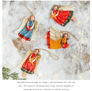 Detailed view of four vintage resin angel ornaments on snow with warm lights.