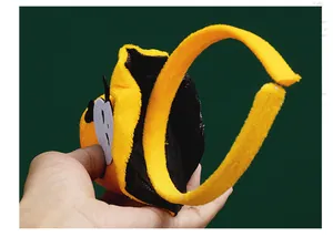 Detailed view of a soft yellow plush Halloween headband accessory for costume parties.