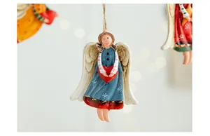 Macro view of a hand-painted retro resin angel ornament with heart and wing details.