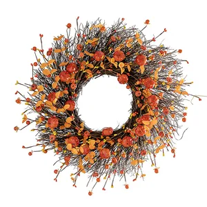 Handcrafted autumn wreath detail with vibrant orange pumpkins and rustic brown twigs