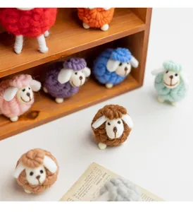 Detailed macro view of various colorful handmade wool felt sheep ornaments for table decor.