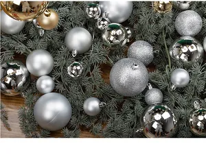 Detailed view of silver Christmas baubles in matte, glitter, and mirror finishes