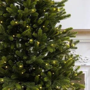 Warm white LED fairy string lights with green copper wire on a lush Christmas tree