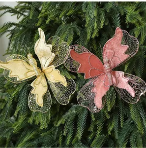 Close-up of gold and pink glitter butterfly ornaments on a Christmas tree.