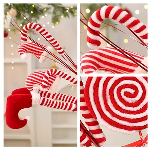 Close-up of red and white striped Christmas tree decorations like elf legs and candy canes.