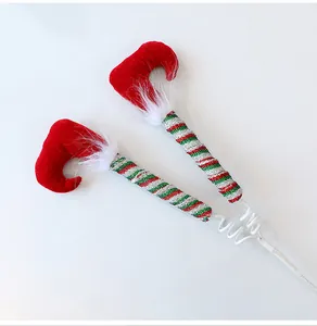 Detailed view of red and green striped elf leg picks for Christmas tree decor