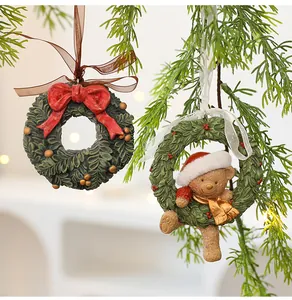 Festive resin Christmas wreath ornaments with red bow and teddy bear hanging detail
