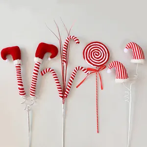 Detailed view of red and white striped Christmas elf leg and candy tree inserts.
