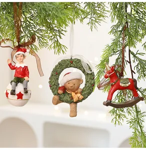 Vintage resin Christmas ornaments featuring elf, bear wreath, and red rocking horse