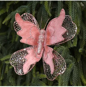 Close-up of a glittering pink fabric butterfly ornament on a green Christmas tree.