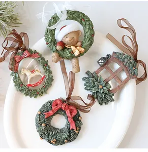 Close-up of four vintage resin Christmas tree hanging ornaments on a white plate