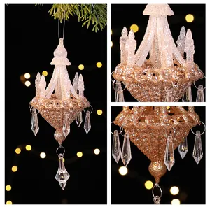 Macro view of gold glitter chandelier Christmas ornament with clear acrylic crystal pendants