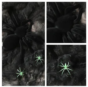 Detailed close-up of black plush spiders and green mini spiders on web decorations