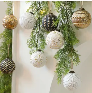 Detailed view of antique style 8cm Christmas ball ornaments hanging on pine branches for holiday.