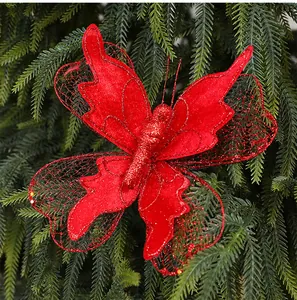 Macro detail of a shimmering red fabric butterfly ornament hanging on Christmas tree