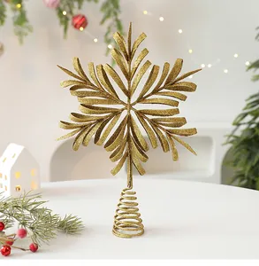 Macro view of gold glitter snowflake Christmas tree topper on a festive table