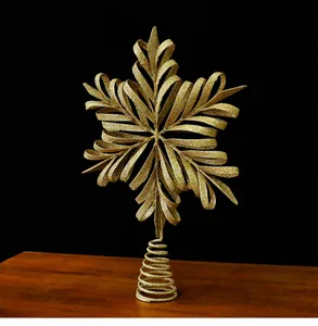 Detailed view of a golden glittery snowflake Christmas tree topper with spiral base.