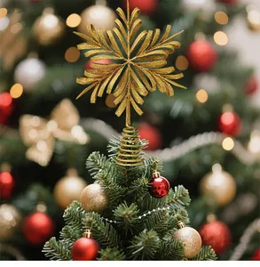Detailed view of a golden glitter snowflake Christmas tree topper on a pine tree