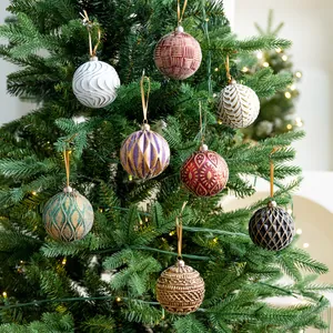 Various 8cm patterned Christmas balls hanging on a decorated festive holiday tree
