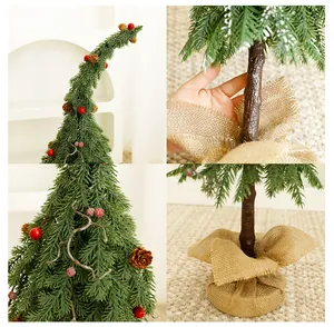 Detail of green bent-top Christmas tree with burlap base and berry ornaments