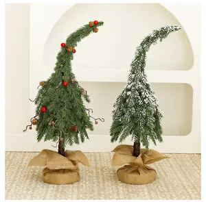 Pair of whimsical curved green mini Christmas trees with burlap base and snow flocking