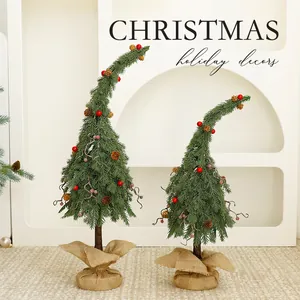 Set of two unique bent green Christmas trees with red berries and rustic burlap base