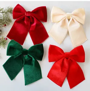 Detailed view of large red green and cream velvet Christmas bows for holiday decor.