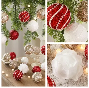 Detailed view of glitter and pearl foam Christmas balls and white rose ornament hanging on tree