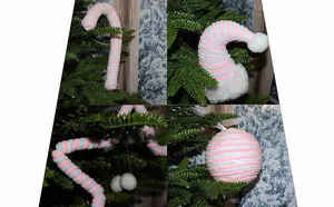 Detailed macro view of pink and blue striped knit Christmas ornaments on a tree.