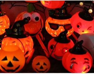 Detail shot of glowing orange Halloween pumpkin lights with various fun facial expressions.