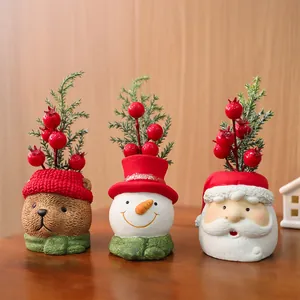 Close-up of festive Christmas resin figures: Santa, Snowman and Bear with red berries
