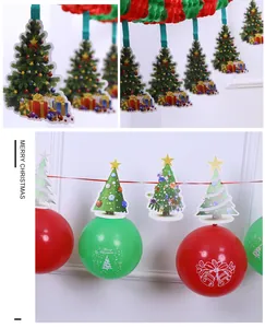 Close-up of Christmas garland banner with festive balloons and tree cutouts