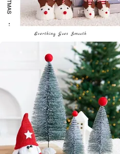 Miniature frosted Christmas trees with red toppers and a festive gnome figurine