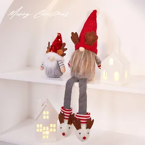 Warm handmade Christmas gnome plush doll ornaments with red reindeer hats on shelf