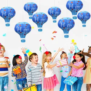 Blue hot air balloon paper lanterns with Ho Ho Ho festive print for Christmas decor.