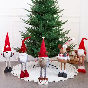 Festive set of five handmade Christmas gnome plush dolls displayed under a decorated pine tree