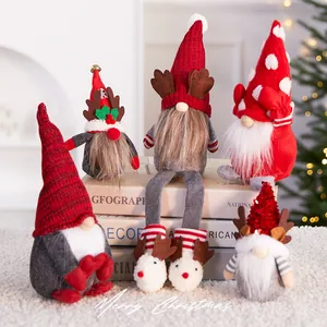 Set of festive Christmas gnome ornaments with red hats and reindeer antlers on books