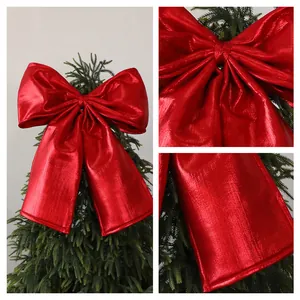 Close-up detail showing the metallic texture and fine stitching of red Christmas bow