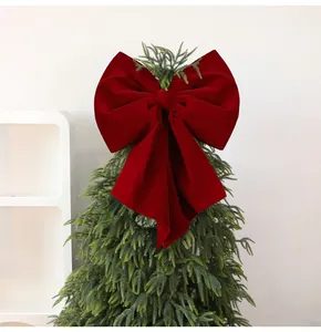 Exquisite large burgundy velvet Christmas bow topper displayed on a green pine tree