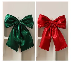 Large red and green Christmas bows with metallic shimmer for festive tree decoration