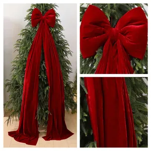 Large burgundy velvet Christmas bow topper for festive tree and window decor.