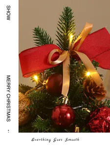 Primo piano di mini albero di Natale con fiocco rosso e luci LED calde.