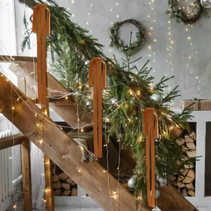Elegant orange velvet bows decorating a wooden Christmas staircase with pine and lights