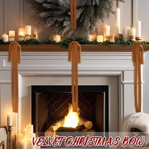 Close-up of velvet Christmas bows decorating a white mantel with festive candles