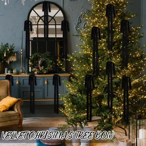 Elegant black velvet Christmas tree bows hanging on a decorated tree in a room