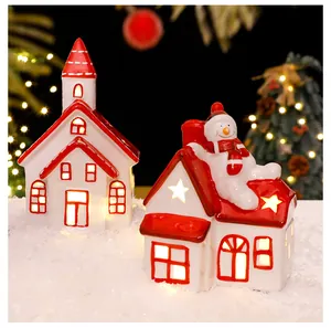 Glowing ceramic Christmas village houses with warm LED lights detail