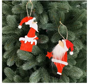 Detailed view of wooden Santa Claus ornaments hanging on a green Christmas tree